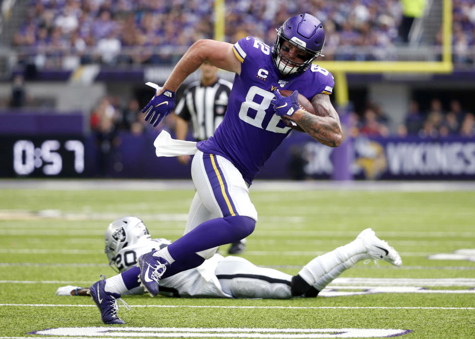 FILE - Minnesota Vikings tight end Kyle Rudolph (82) runs from Oakland Raiders cornerback Daryl Worley (20) after making a reception during the first half of an NFL football game in Minneapolis, Sept. 22, 2019. Two-time Pro Bowl tight end Rudolph has retired after a 12-year career in the NFL he spent mostly with the Vikings. (AP Photo/Bruce Kluckhohn, File)