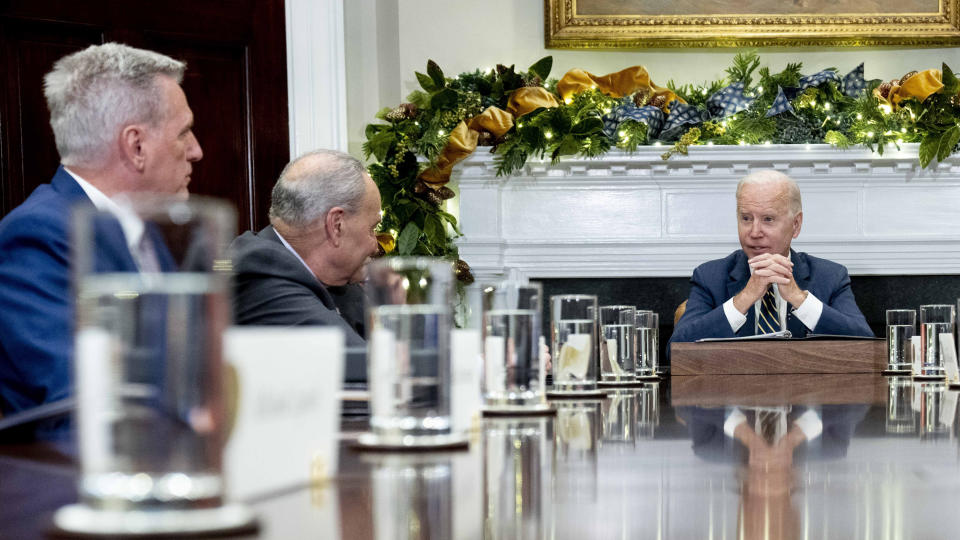 FILE - President Joe Biden, right, at the top of a meeting with congressional leaders to discuss legislative priorities for the rest of the year, Nov. 29, 2022, in the Roosevelt Room of the White House in Washington. From left are House Minority Leader Kevin McCarthy of Calif., Senate Majority Leader Chuck Schumer, of N.Y., and Biden. The president and the House speaker are preparing for their first official visit at the White House on Wednesday, ahead of a looming debt crisis. (AP Photo/Andrew Harnik, File)