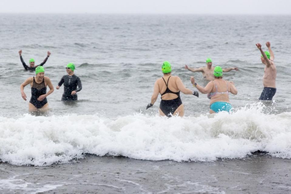 Colleagues of Wall Street Journal reporter Evan Gershkovich take a plunge at Brighton Beach in Brooklyn on Saturday to call for his release as the one-year anniversary of his arrest in Russia nears. Aristide Economopoulos