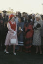 During a royal state visit to Botswana, Her Majesty stole the spotlight in a red pussy-bow dress complete with a matching sleeveless knit and floral hat. <em>[Photo: Getty]</em>