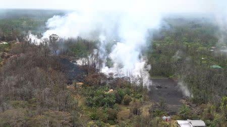 Molten rock flows and burst to the surface, threatening homes in a rural area in this still image from an aerial video taken from a Hawaii Army National Guard a week after the eruption of the Kilauea volcano, in Pahoa, Hawaii, U.S., May 10, 2018. Courtesy Andrew Jackson/Hawaii DoD/Handout via REUTERS