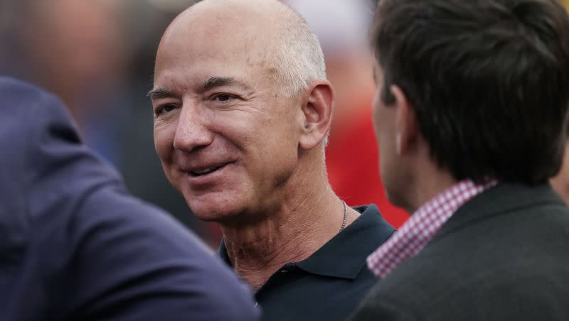 Amazon founder Jeff Bezos is seen on the sidelines before the start of an NFL football game, Sept. 15, 2022, in Kansas City, Mo. After nearly three decades, Bezos is leaving Seattle. In a Instagram post, the Amazon founder announced plans to return to Miami — where he spent his high school years — to be closer to his parents and his partner, Lauren Sánchez.