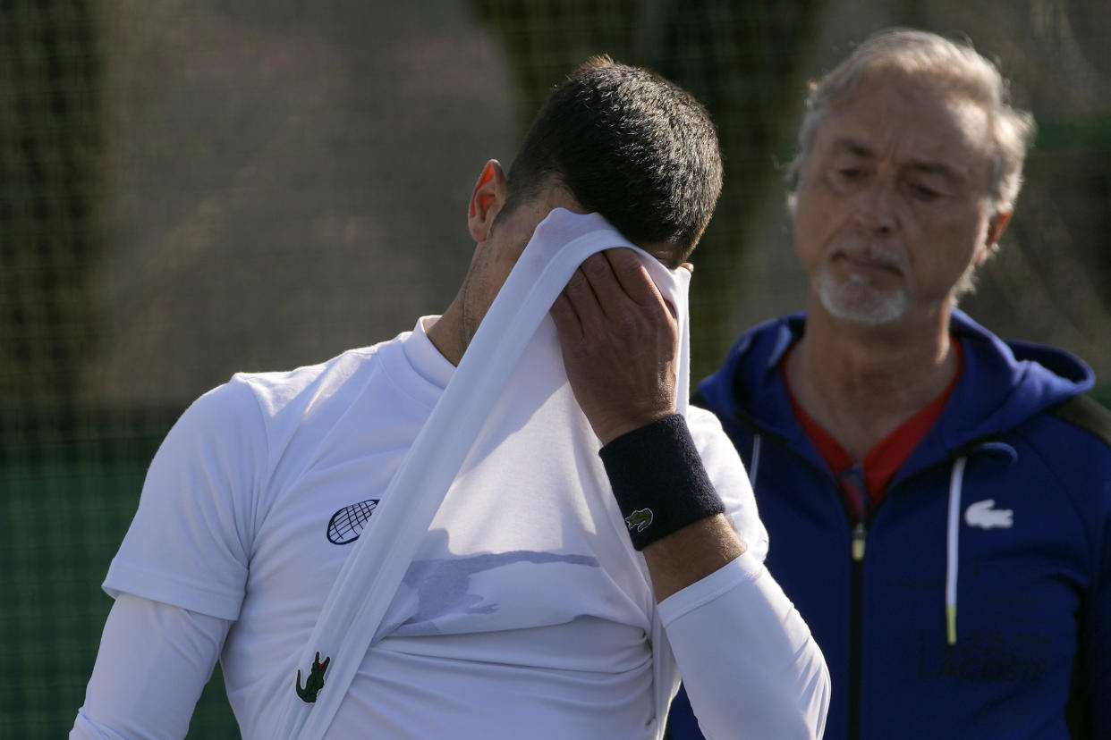 Serbian tennis player Novak Djokovic with his coach Marco Panichi, right, during his open practice session in Belgrade, Serbia, Wednesday, Feb. 22, 2023. Djokovic said Wednesday he still hopes US border authorities would allow him entry to take part in two ATP Masters tennis tournaments despite being unvaccinated against the coronavirus. (AP Photo/Darko Vojinovic)