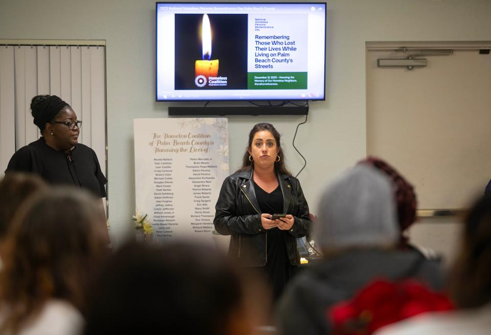 Jesi Moler-Catala, executive assistant with the Palm Beach County Homeless Coalition and colleague Celissa Stringer take part in a ceremony part of National Homeless Persons' Remembrance Day at the The Senator Philip D. Lewis Center December 21, 2023 in West Palm Beach.