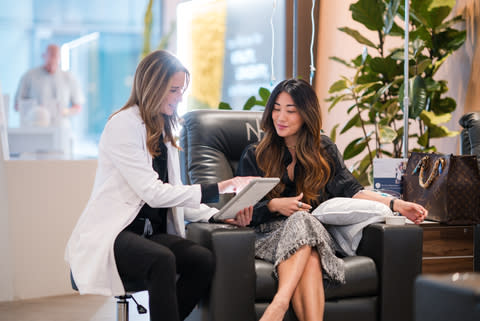 Next Health West Hollywood IV Lounge; providers and patients reviewing IV therapy menus, NAD+ therapy, and executive physical exam packages.  (Photo: Business Wire)