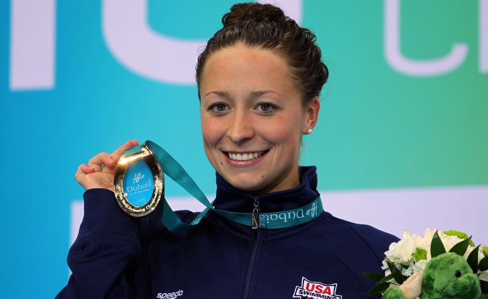 Ariana Kukors poses with her gold medal after winning the Women's 100-meter Individual Medley final of the 10th FINA World Swimming Championships in 2010 in Dubai, United Arab Emirates. (Photo: Clive Rose/Getty Images)