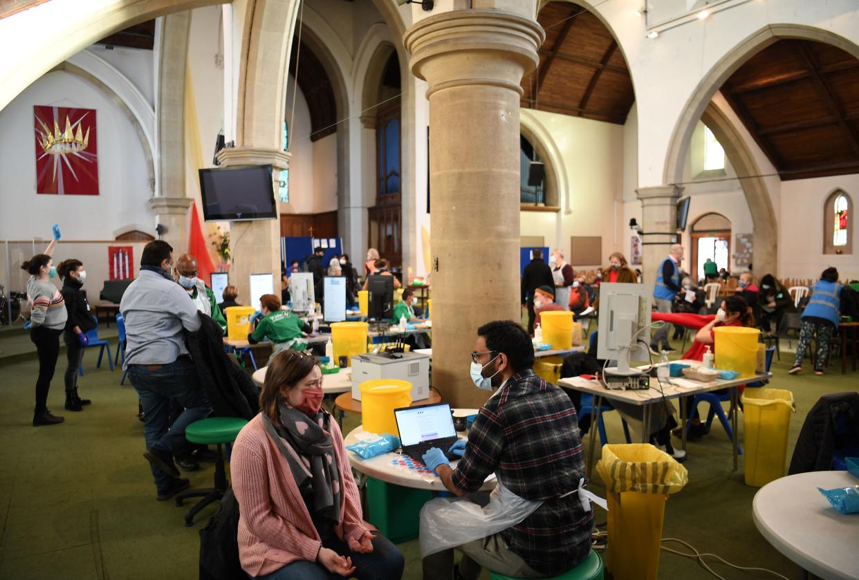 A member of the public prepares to receive a Covid-19 Moderna booster vaccine jab at a temporary coronavirus vaccination centre set up inside St John's Church in west London on December 4, 2021. - Britain, which has been among the hardest hit by Covid-19 with more than 145,000 deaths, is racing to offer third doses of coronavirus vaccines to all adults aged over 18 through its state-run National Health Service. (Photo by Daniel LEAL / AFP) (Photo by DANIEL LEAL/AFP via Getty Images)