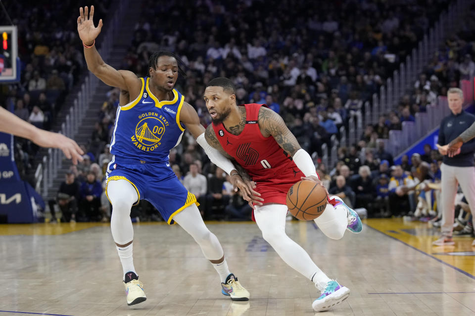 Portland Trail Blazers guard Damian Lillard (0) drives to the basket against Golden State Warriors forward Jonathan Kuminga (00) during the first half of an NBA basketball game in San Francisco, Tuesday, Feb. 28, 2023. (AP Photo/Jeff Chiu)