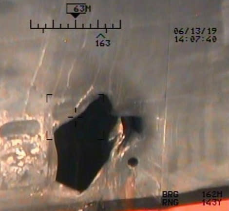 This image released by the U.S. Department of Defense on Monday, June 17, 2019, and taken from a U.S. Navy helicopter, shows what the Navy says is blast damage to the motor vessel M/T Kokuka Courageous, consistent with a limpet mine attack. (U.S. Department of Defense via AP)