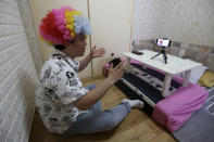 In this July 18, 2019, photo, North Korean refugee Jang Myung-jin films himself in a demonstration of his YouTube broadcast during an interview at his house in Seoul, South Korea. The 32-year-old Jang is among a handful of young North Korean refugees in South Korea who have launched YouTube channels that offer a rare glimpse into the everyday lives of people in North Korea, one of the world’s most secretive and repressive countries. (AP Photo/Ahn Young-joon)