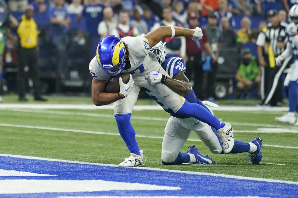 Los Angeles Rams wide receiver Puka Nacua, left, scores a touchdown as Indianapolis Colts safety Julian Blackmon defends during overtime in an NFL football game, Sunday, Oct. 1, 2023, in Indianapolis. | Michael Conroy, Associated Press
