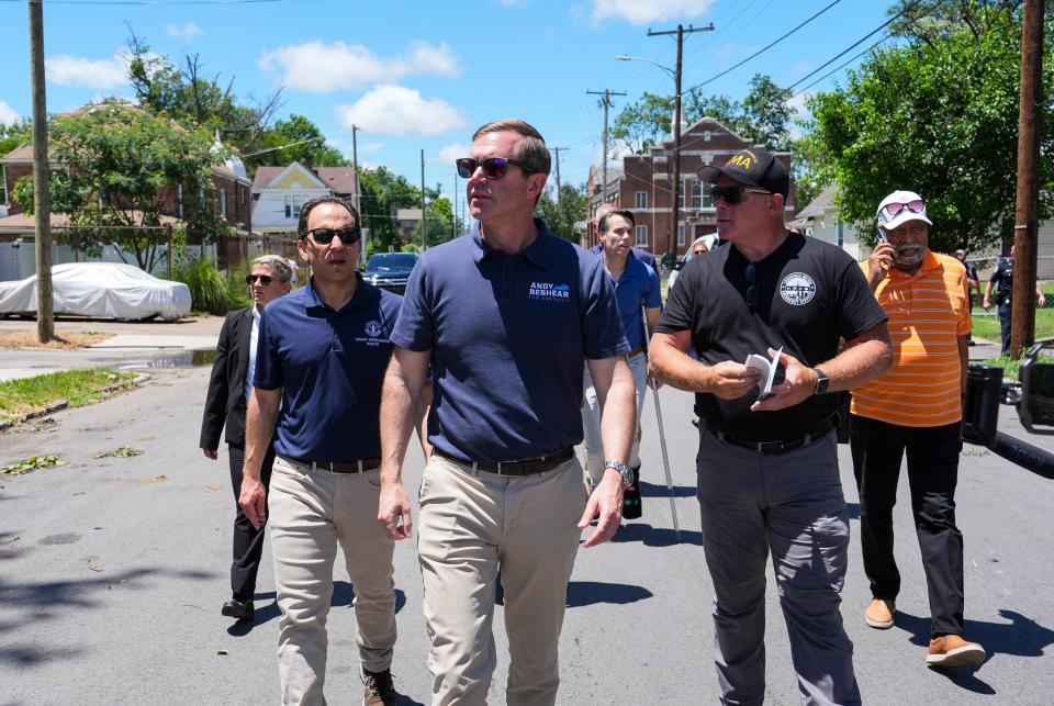 Kentucky Gov. Andy Beshear visited west Louisville's Parkland neighborhood to survey the storm damage after an E1 tornado on the Fourth of July damaged several homes in Louisville, Kentucky. Walking with Beshear is Louisville Mayor Craig Greenberg, left; Louisville EMA executive director Edward Jody Meiman; and Kentucky Sen. Gerald Neal at far right. Behind them is U.S. Senator Morgan McGarvey on crutches.