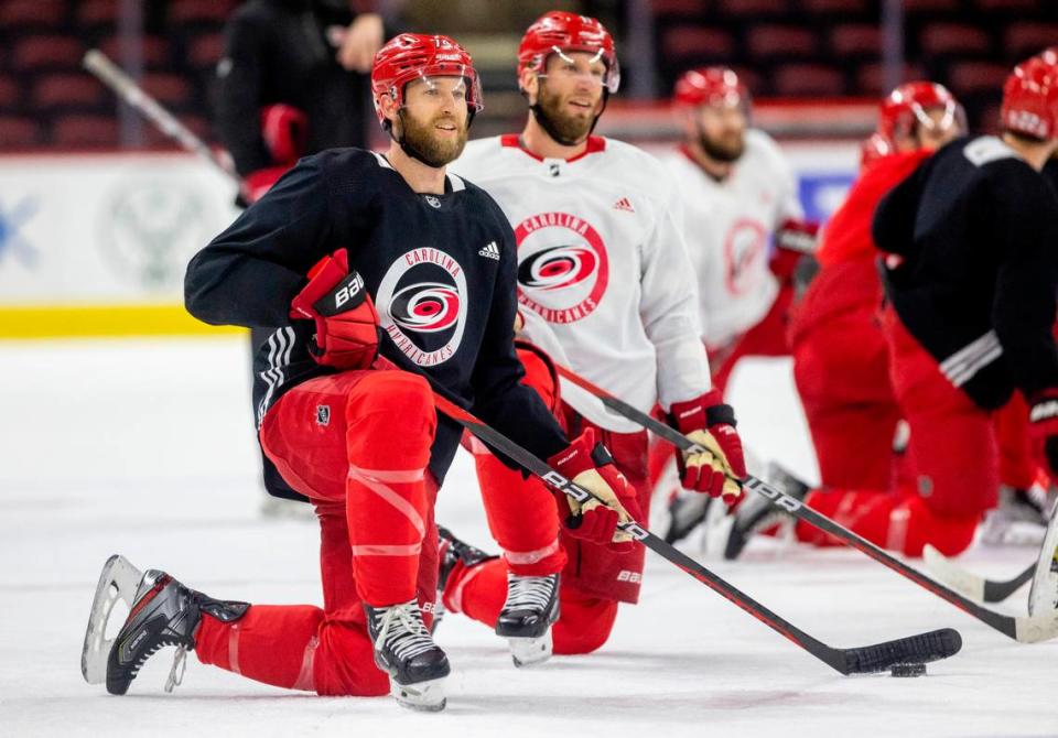 The Carolina Hurricanes Jaccob Slavin (74) and <a class="link " href="https://sports.yahoo.com/nhl/players/3980" data-i13n="sec:content-canvas;subsec:anchor_text;elm:context_link" data-ylk="slk:Jordan Staal;sec:content-canvas;subsec:anchor_text;elm:context_link;itc:0">Jordan Staal</a> (11) take turns shooting from the kneeling position during practice on Monday, May 15, 2023 at PNC Arena in Raleigh, N.C. Robert Willett/rwillett@newsobserver.com