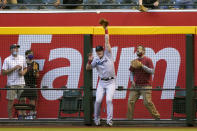 Miami Marlins' Garrett Cooper can't catch a double hit by Arizona Diamondbacks' Asdrubal Cabrera during the first inning of a baseball game, Tuesday, May 11, 2021, in Phoenix. (AP Photo/Matt York)