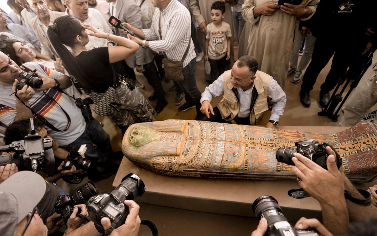 Mostafa Waziri, secretary general of the Supreme Council of Antiquities, displays a recently unearthed ancient wooden sarcophagus - Amr Nabil/AP