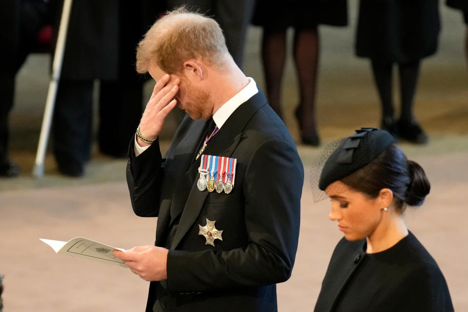 LONDON, ENGLAND - SEPTEMBER 14: An emotional Prince Harry, Duke of Sussex and Meghan, Duchess of Sussex pay their respects in The Palace of Westminster after the procession for the Lying-in State of Queen Elizabeth II on September 14, 2022 in London, England. Queen Elizabeth II's coffin is taken in procession on a Gun Carriage of The King's Troop Royal Horse Artillery from Buckingham Palace to Westminster Hall where she will lay in state until the early morning of her funeral. Queen Elizabeth II died at Balmoral Castle in Scotland on September 8, 2022, and is succeeded by her eldest son, King Charles III.  (Photo by Christopher Furlong/Getty Images)