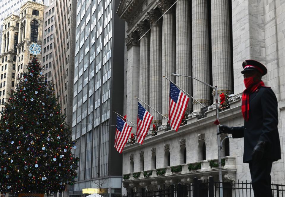 A Salvation Army volunteer dances in front of the New York Stock exchange (NYSE) at Wall Street on December 9, 2020 in New York City. (Photo by Angela Weiss / AFP) (Photo by ANGELA WEISS/AFP via Getty Images)