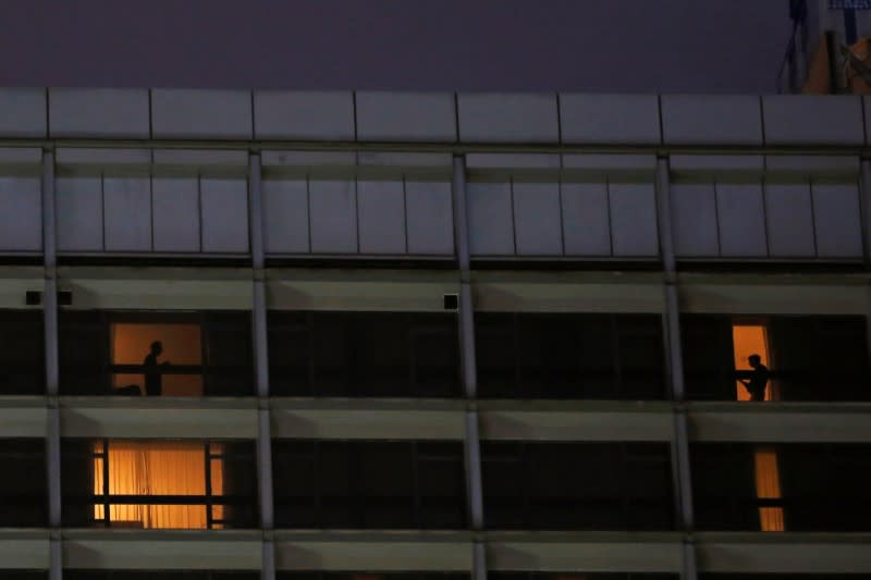 Guests are seen through the windows of a hotel, following the coronavirus disease (COVID-19) outbreak, in Hong Kong