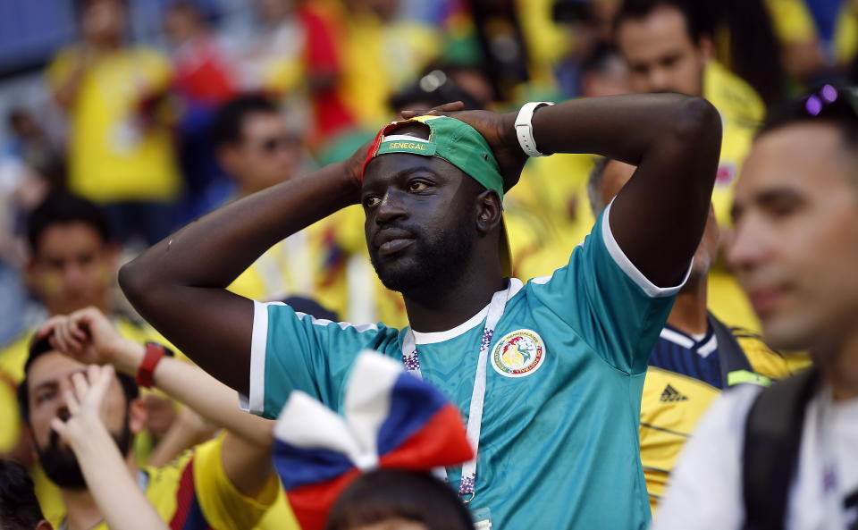 <p>A Senegal fan is upset after his team missed out on the knockout rounds by the finest of margins </p>
