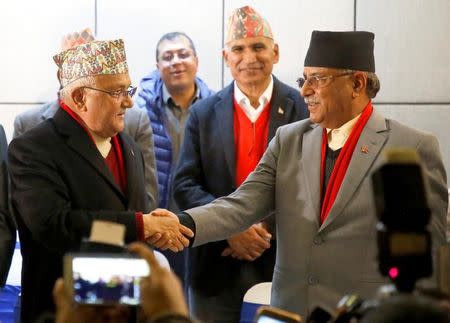 File Photo: Chairman of Communist Party of Nepal (Unified Marxist-Leninist) (CPN-UML) party Khadga Prasad Sharma Oli, also known as K.P. Oli, (L) shakes hands with the chairman of Communist Party of Nepal (Maoist Centre) Pushpa Kamal Dahal, also known as Prachanda, during a news conference in Kathmandu, Nepal December 17, 2017. REUTERS/Navesh Chitrakar