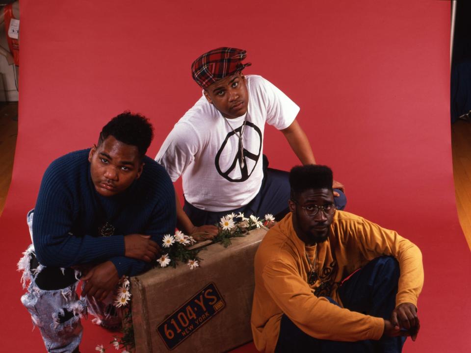 A group photo of De La Soul posing for a studio portrait