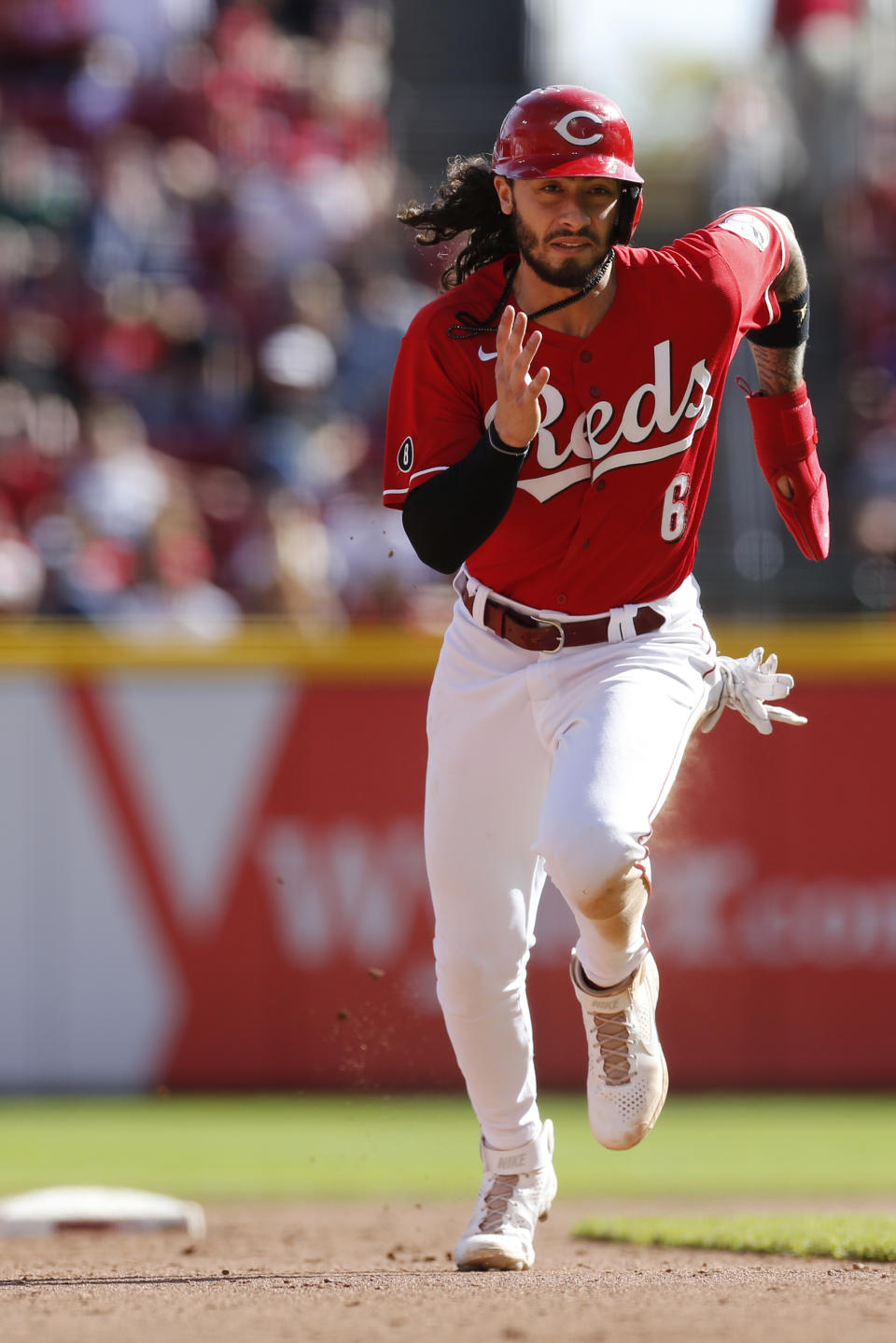 Cincinnati Reds' Jonathan India advances to third on a fly ball sacrifice against the Washington Nationals during the seventh inning of a baseball game Sunday, Sept. 26, 2021, in Cincinnati. The Reds defeated the Nationals 9-2. (AP Photo/Jay LaPrete)