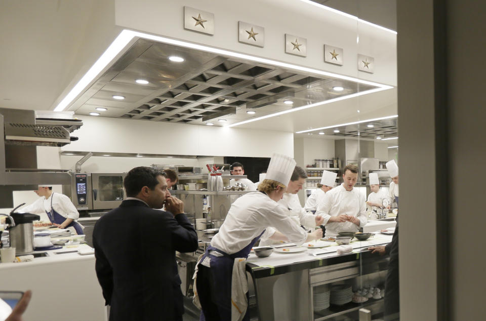 FILE - In this March 9, 2017, file photo, general manager Michael Minnillo watches over dinner service in the kitchen of the French Laundry restaurant in Yountville, Calif. A former employee of celebrated chef Thomas Keller is suing him and his three-star Michelin restaurants, Per Se in New York and the French Laundry in California, for discrimination, saying she was denied a job transfer and ultimately let go because she was pregnant. Vanessa Scott-Allen is seeking $5 million in damages for allegations that include sex discrimination and violation of pregnancy disability leave and says she hopes her trial, which starts Monday, June 3, 2019, will draw attention to a "culture of misogyny in fine dining," said her attorney, Carla Minnard. (AP Photo/Eric Risberg, File)