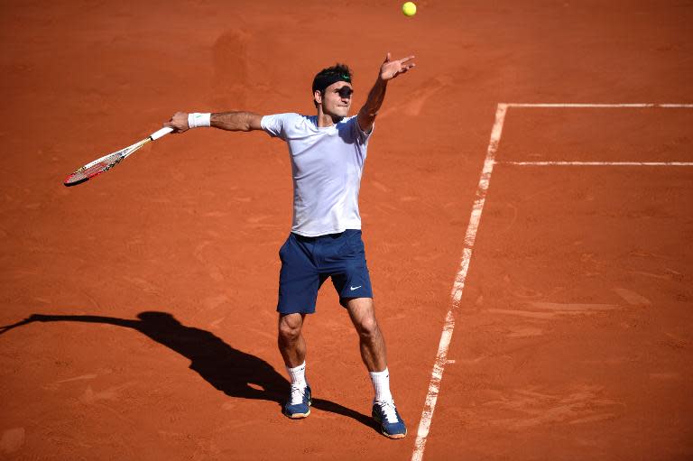Switzerland's Roger Federer serves to France's Jo-Wilfried Tsonga during their 2013 French Open quarter-final match, at the Roland Garros stadium in Paris, on June 4, 2013