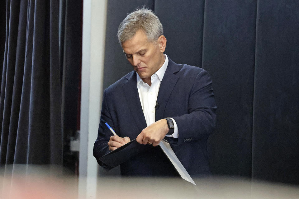 North Carolina gubernatorial candidate Josh Stein writes down some final notes before being called to the podium at a rally at Shaw University in Raleigh, N.C., Tuesday, Oct. 10, 2023. (AP Photo/Karl B DeBlaker)