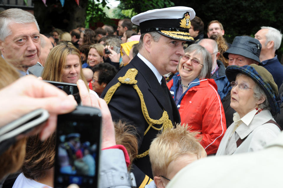 LONDON, ENGLAND - JUNE 03: Prince Andrew, Duke of York (R) attends the 'Big Jubilee Lunch' at All Saints Church in Fulham ahead of the Diamond Jubilee River Pageant on June 3, 2012 in London, England. For only the second time in its history the UK celebrates the Diamond Jubilee of a monarch. Her Majesty Queen Elizabeth II celebrates the 60th anniversary of her ascension to the throne. Thousands of well-wishers from around the world have flocked to London to witness the spectacle of the weekend's celebrations. The Queen along with all members of the royal family will participate in a River Pageant with a flotilla of a 1,000 boats accompanying them down The Thames. (Photo by Matt Grayson - WPA Pool/Getty Images)