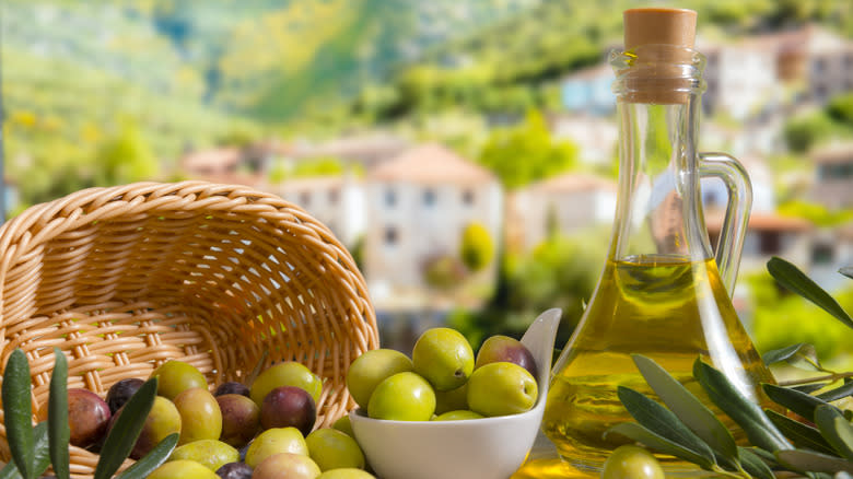 olives and oil with Tuscan background