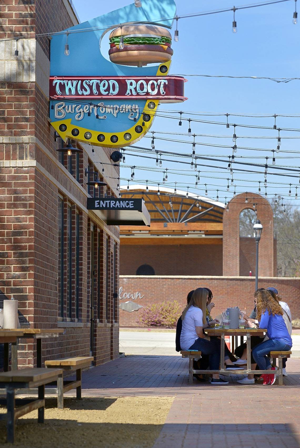 Customers eat lunch outside the Twisted Root shortly after it opened in downtown Mansfield in early 2018.