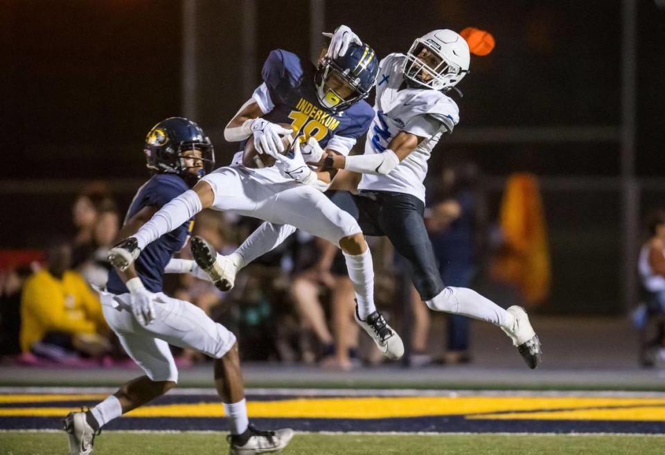 Inderkum Tigers defensive back Lono Chouteau (18) intercepts a pass intended for Capital Christian Cougars wide receiver Titus White (2) during the second quarter at their high school football game Aug. 24 at Inderkum High School in Sacramento.