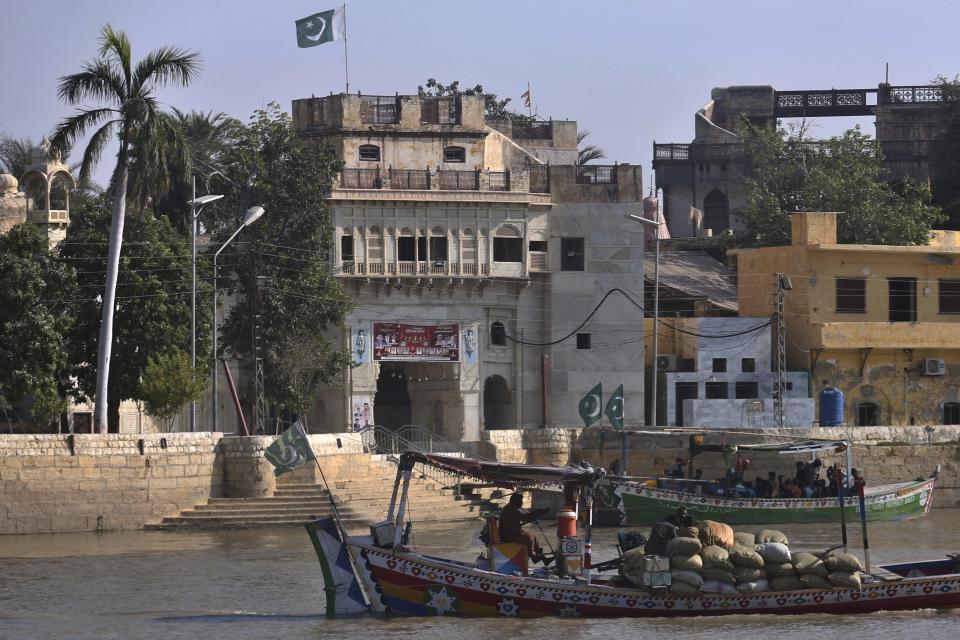 People from Pakistani Hindu community leave through boats after visiting at the Sadhu Bela temple, located in an island on the Indus River, in Sukkur, Pakistan, Wednesday, Oct. 26, 2022. On the banks of the Indus River, which flows through Pakistan and into its southern Sindh province, Hindus wait for brightly colored boats to ferry them to an island that has housed Sadhu Bela temple for almost 200 years. The island was gifted to the Hindu community by wealthy Muslim landlords in Sindh, an unthinkable act in modern-day Pakistan. (AP Photo/Fareed Khan)