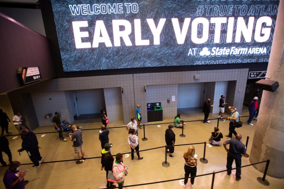 Voters line up inside State Farm Arena, Georgia’s largest early voting location, for the first day of early voting in the general election on Oct. 12, 2020, in Atlanta. <a href="https://www.gettyimages.com/detail/news-photo/voters-line-up-inside-of-state-farm-arena-georgias-largest-news-photo/1229030627?phrase=2020%20election%20voting%20lines%20Georgia&adppopup=true" rel="nofollow noopener" target="_blank" data-ylk="slk:Jessica McGowan/Getty Images;elm:context_link;itc:0;sec:content-canvas" class="link ">Jessica McGowan/Getty Images</a>