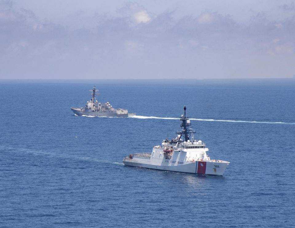 In this photo provided by U.S. Coast Guard, Legend-class U.S. Coast Guard National Security Cutter Munro (WMSL 755) transits the Taiwan Strait during a routine transit with Arleigh Burke class guided-missile destroyer USS Kidd (DDG 100) on Aug. 27, 2021. China's defense ministry protested Saturday the passage of a U.S. Navy warship and Coast Guard cutter through the waters between China and Taiwan, a self-governing island claimed by China.(U.S. Coast Guard via AP)