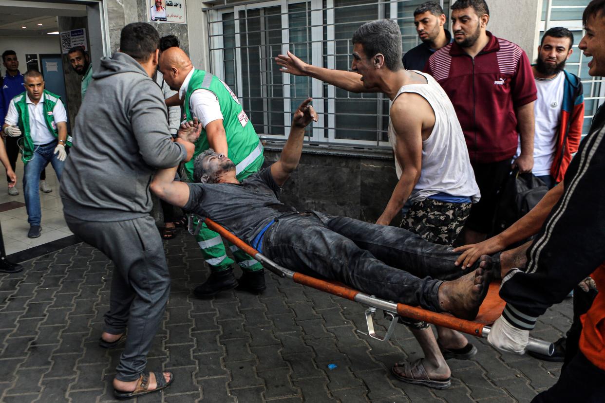 An injured Palestinian man is carried on a stretcher into the al-Shifa Hospital (Copyright 2023 The Associated Press. All rights reserved.)