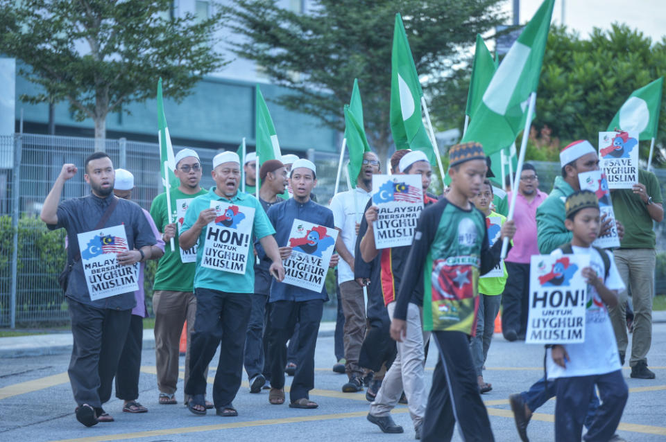 Protesters hold placards and march as they attend a ‘silent protest’ by Angkatan Belia Islam Malaysia (Abim) and Global Peace Mission (GPM) Malaysia at BACC in Kajang December 21, 2019. — Picture by Shafwan Zaidon