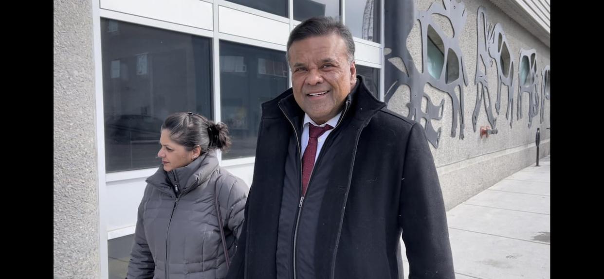 Ron Barlas (right) and wife Zeba Barlas enter the Yellowknife courtroom on Wednesday. (Robert Holden / CBC - image credit)