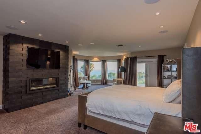 <p>The master suite has a cozy fireplace and a wrap-around patio with views of the ocean. <br> (Realtor.com) </p>