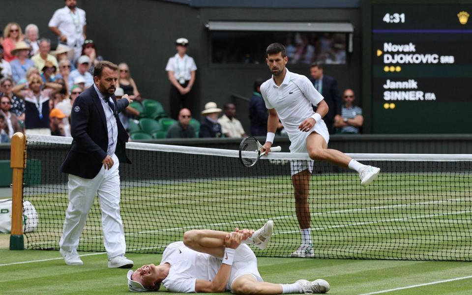 Djokovic clambers over the net to go to Sinner's aid - ADRIAN DENNIS/AFP via Getty Images