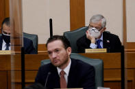 Rep. Top Craddick, R-Midland, right, listens to a witness as the Committees on State Affairs and Energy Resources holds a joint public hearing to consider the factors that led to statewide electrical blackouts, Thursday, Feb. 25, 2021, in Austin, Texas. The hearings were the first in Texas since a blackout that was one of the worst in U.S. history, leaving more than 4 million customers without power and heat in subfreezing temperatures. (AP Photo/Eric Gay)
