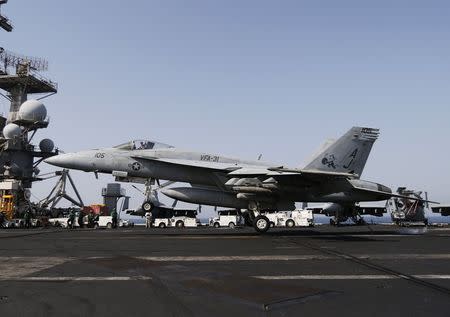 A F/A-18E Super Hornet of Strike Fighter Squadron (VFA-31) gets arrested in the landing gear onboard the flight deck of the aircraft carrier USS George H.W. Bush (CVN 77), in the Gulf August 12, 2014. . REUTERS/Hamad I Mohammed