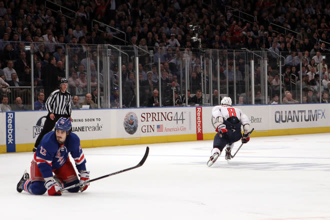 NEW YORK, NY - APRIL 30: Alex Ovechkin #8 of the Washington Capitals celebrates after he scored a goal in the third period to take a 3-2 lead as Brian Boyle #22 of the New York Rangers looks on dejected while kneeling on the ice in Game Two of the Eastern Conference Semifinals during the 2012 NHL Stanley Cup Playoffs at Madison Square Garden on April 30, 2012 in New York City. (Photo by Bruce Bennett/Getty Images)