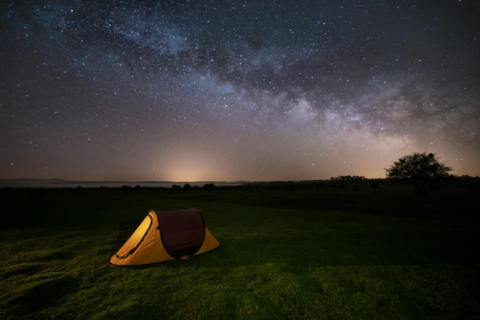 A tent underneath the starry night sky