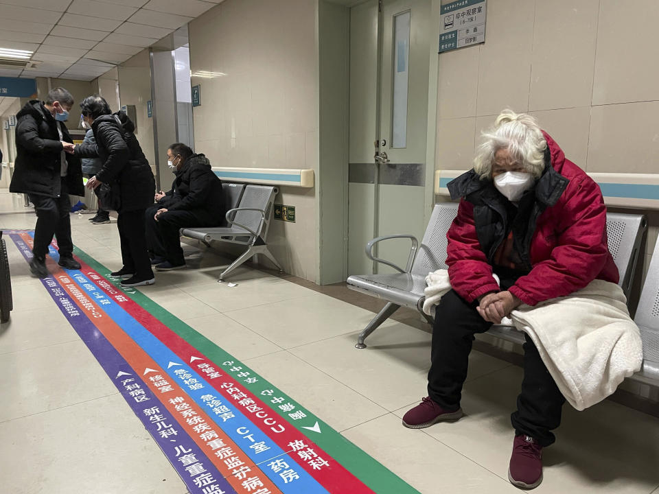 FILE - Visitors wait in the emergency department at the Baoding No. 2 Central Hospital in Zhuozhou city in northern China's Hebei province on Wednesday, Dec. 21, 2022. Nearly three years after it was first identified in China, the coronavirus is now spreading through the vast country. Experts predict difficult months ahead for its 1.4 billion people. (AP Photo, File)
