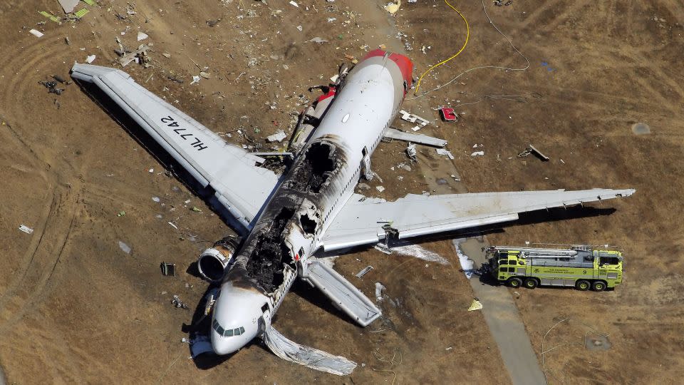 The destroyed fuselage of Asiana Airlines Flight 214 is visible on the runway at San Francisco International Airport after it crashed on landing and burned on Saturday, July 6, 2013. - Carlos Avila Gonzalez/The San Francisco Chronicle/Getty Images/File