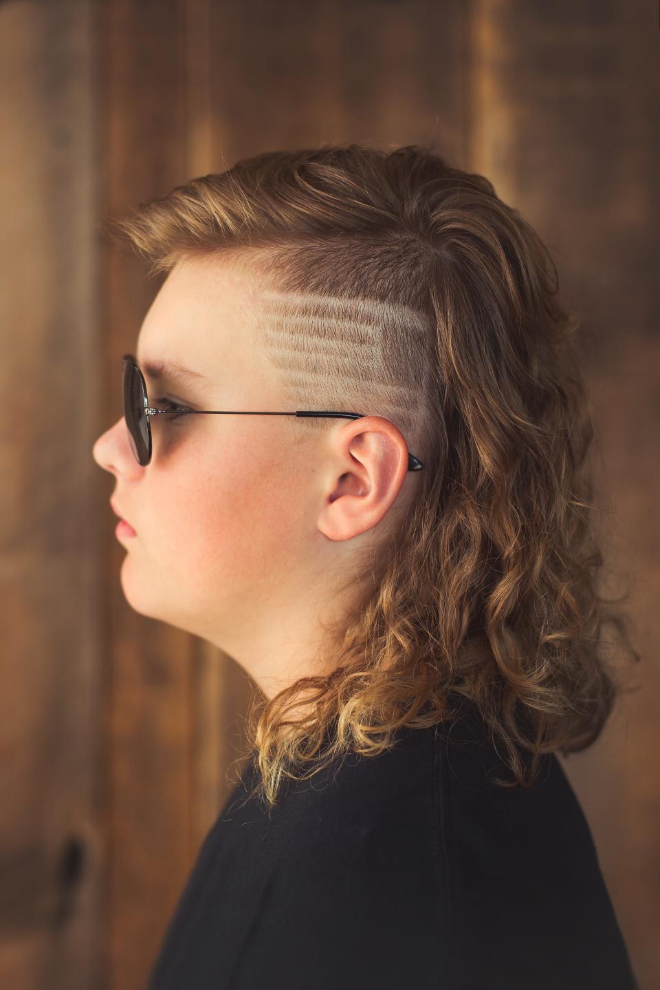 Max Weihbrecht, 13, of Lawrence, Wisconsin poses for his side profile picture to enter the USA Mullet Championships.