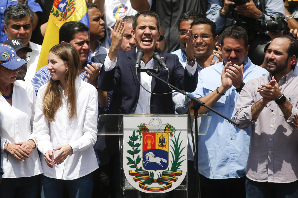 Venezuelan Congress President Juan Guaido, an opposition leader who declared himself interim president, speaks during a rally demanding the resignation of Venezuelan President Nicolas Maduro, next to his wife Fabiana Rosales in Caracas, Venezuela, Monday, March 4, 2019. The United States and about 50 other countries recognize Guaido as the rightful president of Venezuela, while Maduro says he is the target of a U.S.-backed coup plot (AP Photo/Eduardo Verdugo)