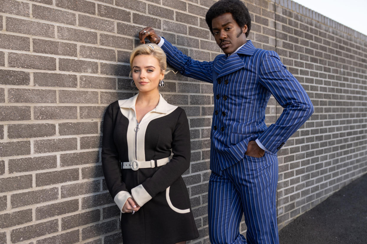 Doctor Who stars Ncuti Gatwa and Millie Gibson leaning against a brick wall